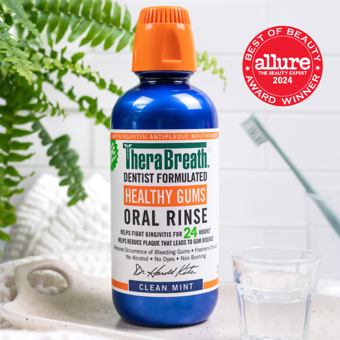A blue bottle of TheraBreath Healthy Gums Oral Rinse in Clean Mint marked as the "Allure the Beauty Expert 2024 Best of Beauty Award Winner"