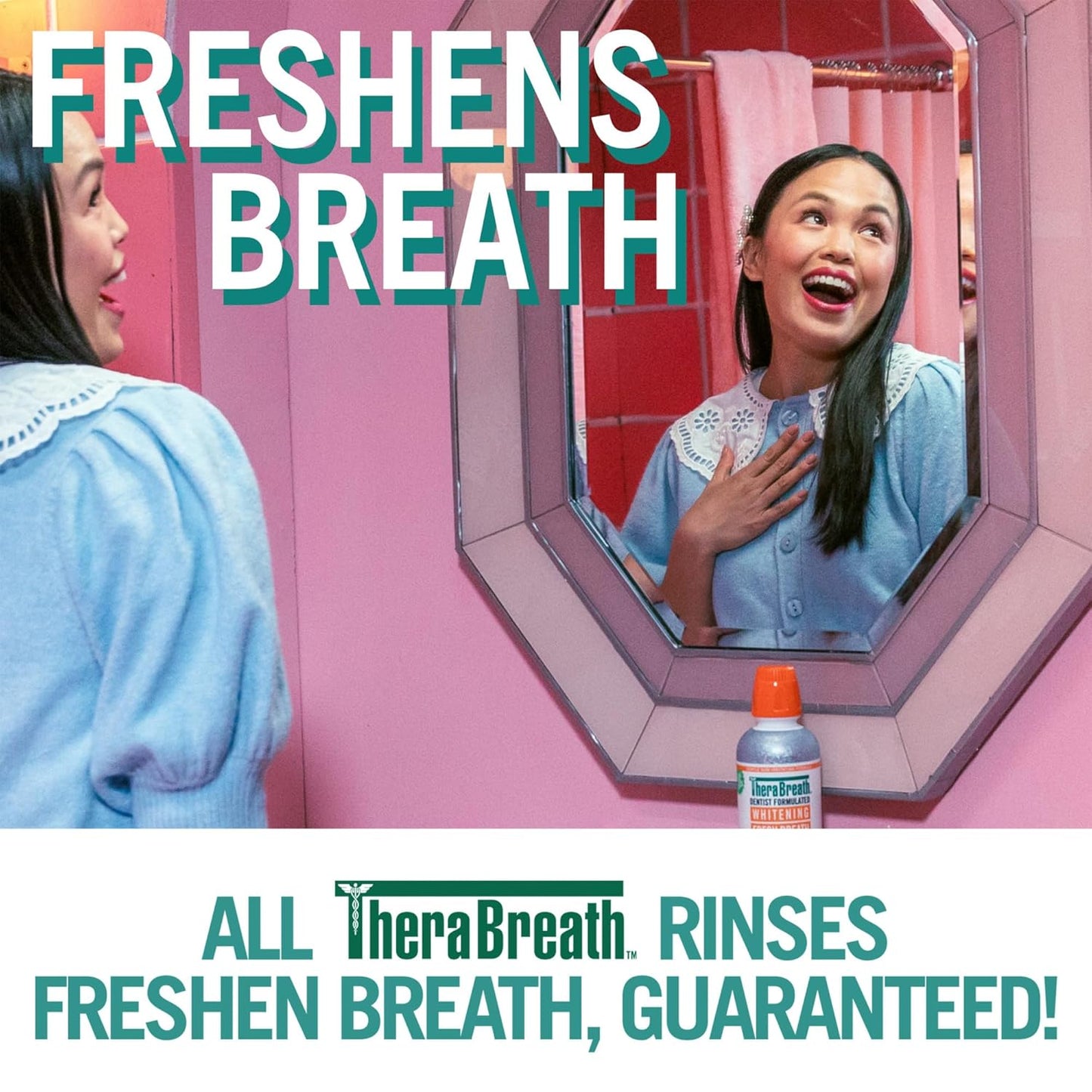 Woman smiling in front of the mirror. The words "Freshens Breath" is at the top of the image, with the message "All TheraBreath rinses freshen breath, guaranteed!" at the bottom.