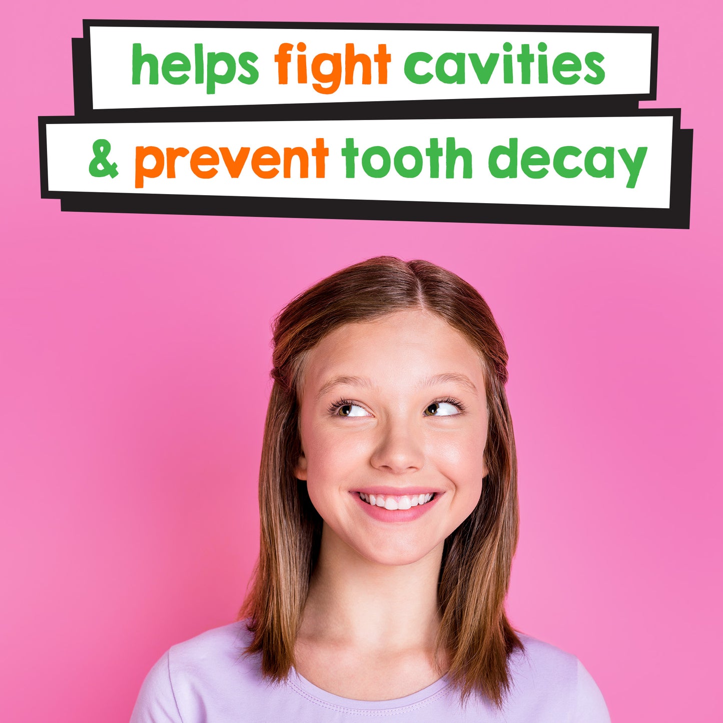 Girl smiling with the words "Helps fight cavities & prevent tooth decay" written playfully above her head. The background is a vibrant pink. 