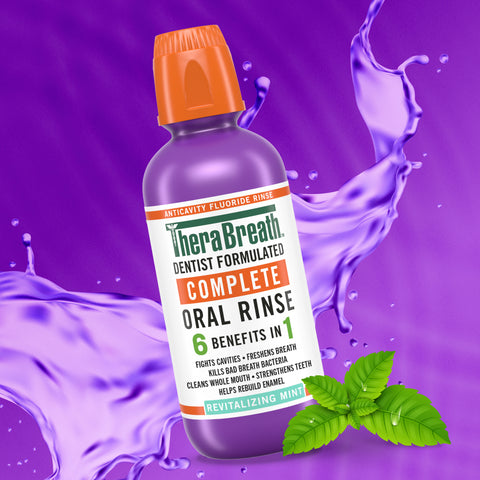 TheraBreath purple bottle complete oral rinse 6 benefits in 1 in revitalizing mint flavor on a purple background.
