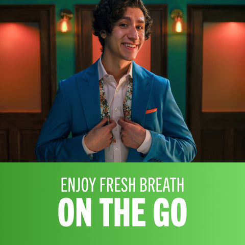 man smiling after using TheraBreath oral rinse with the caption enjoy fresh breath on the go.