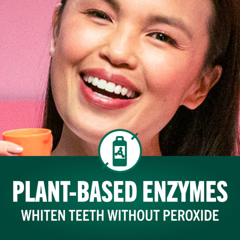 A woman smiling holding therabreath orange cap with the caption plant based enzymes whiten teeth without peroxide