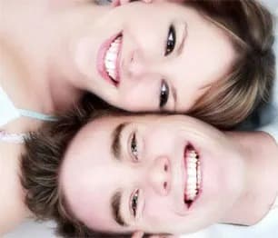 Couple smiling with very white teeth